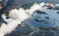 Tourists fly over the Victoria Falls on the trikes. Royalty Free Stock Photo